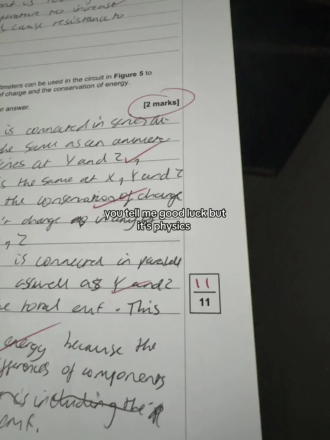 Ash's marked physics practice paper from his TikTok video
